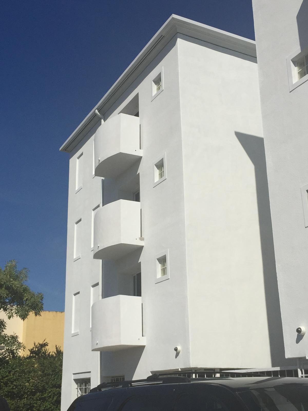 White apartment building with curved balconies