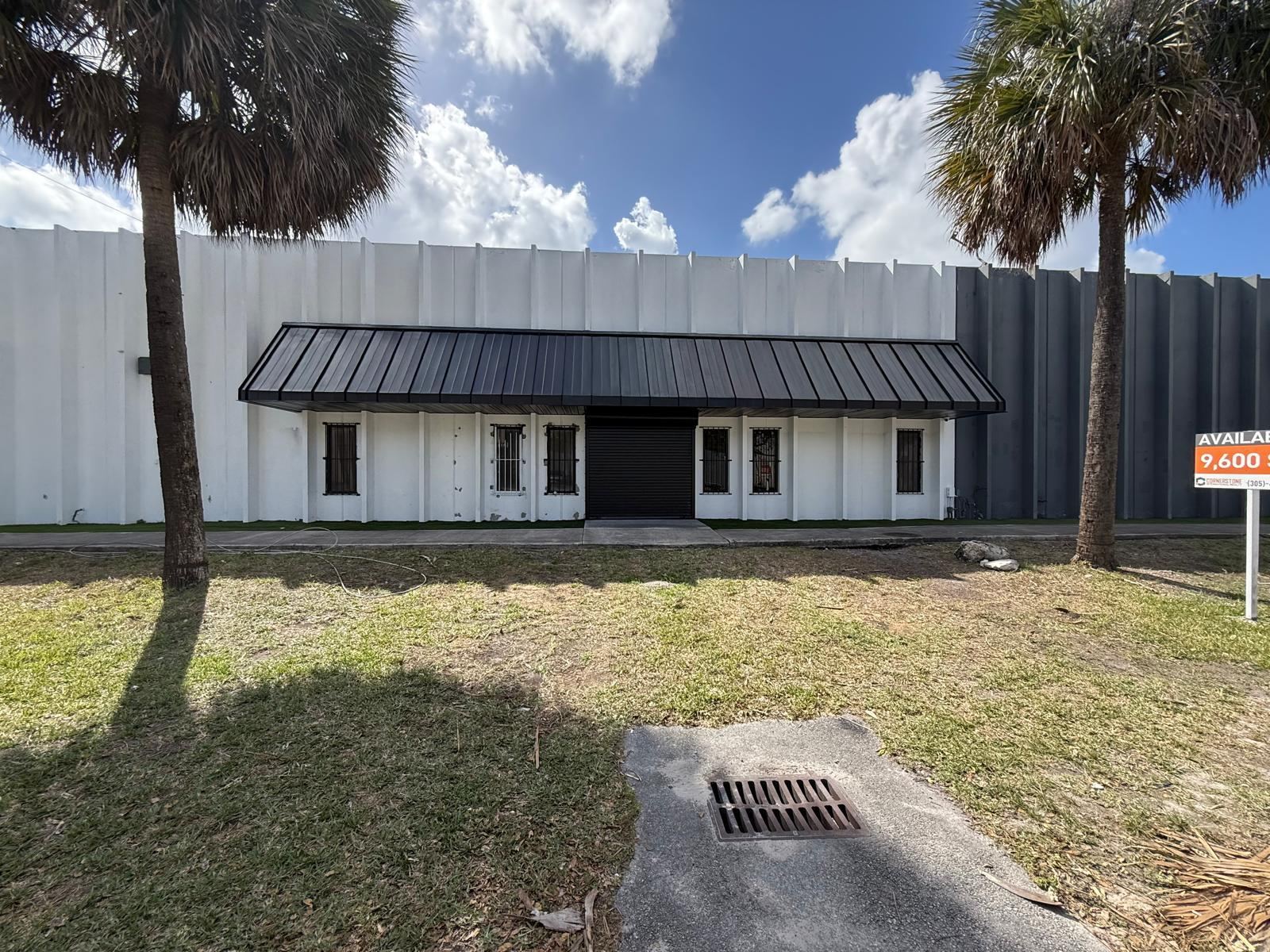 Commercial storefront after painting, with a new black awning