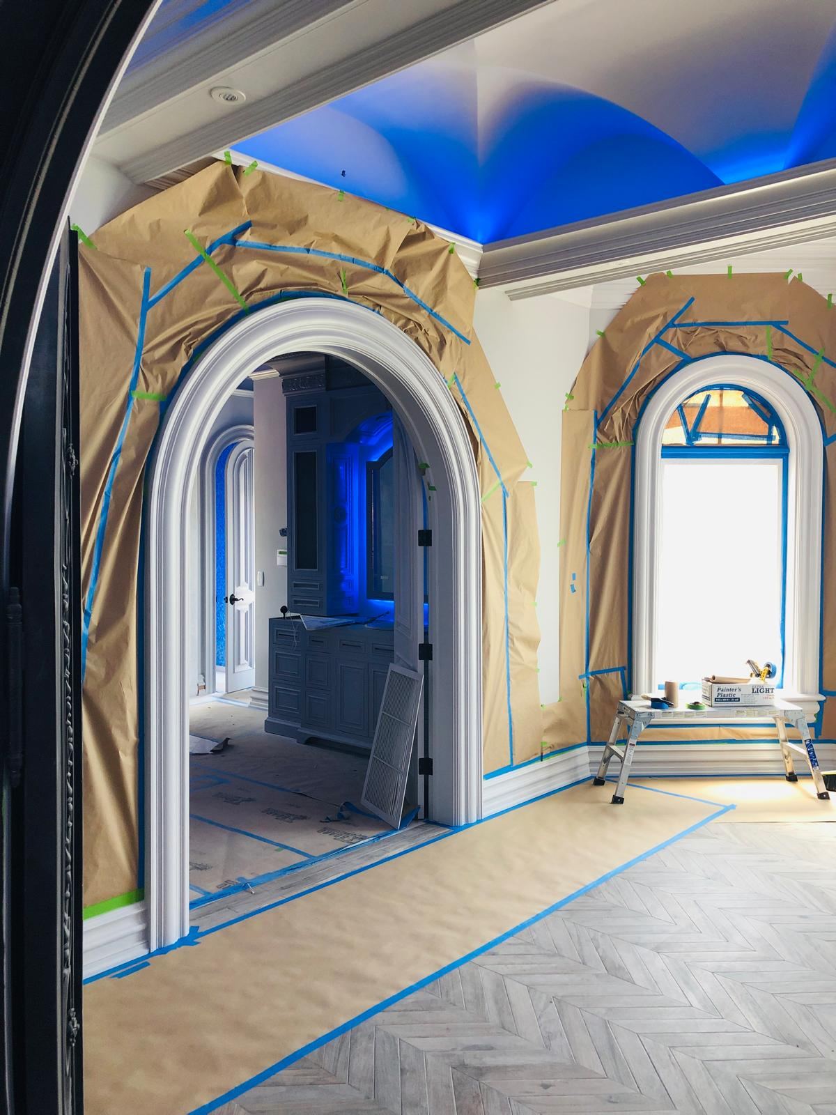 Arched doorways fully masked with paper and tape before spraying